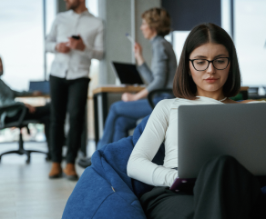 smart-woman-is-sitting-and-uses-laptop-people-are-2024-02-29-22-12-56-utc (1)